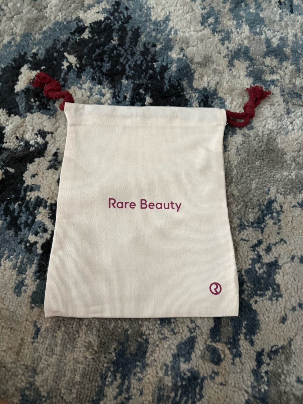 Rare Beauty Cream Drawstring Pouch with Burgundy Cord Accents
